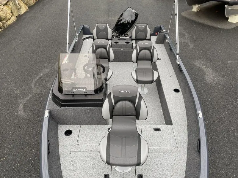 Slide: The Image of 2025 Lund 1650 Rebel XL boat interior with gray seating and modern design. - 12