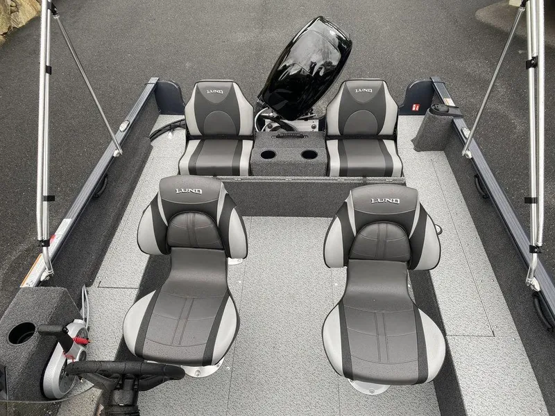 Slide: The Image of 2025 Lund 1650 Rebel XL boat interior with four gray seats and steering console. - 13