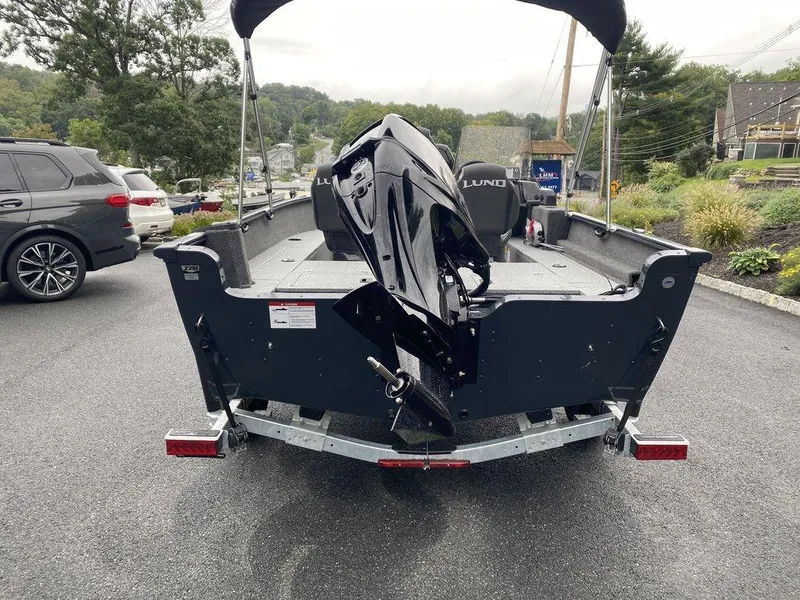 Slide: The Image of 2025 Lund 1650 Rebel XL boat on trailer, parked outdoors. - 3