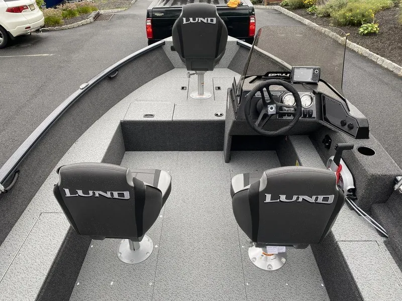 Slide: The Image of 2025 Lund 1650 Rebel XL boat interior with steering console and seating. - 8