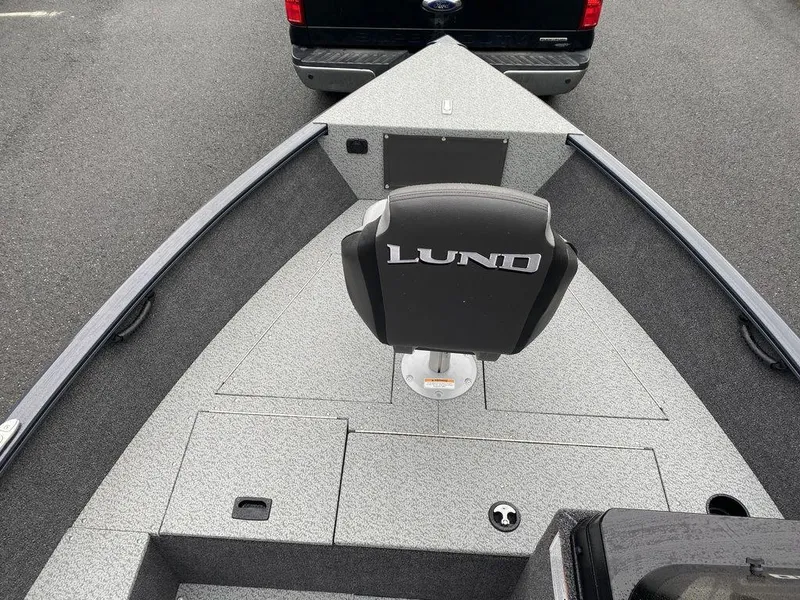 Slide: The Image of 2025 Lund 1650 Rebel XL boat interior with seating and storage compartments. - 9