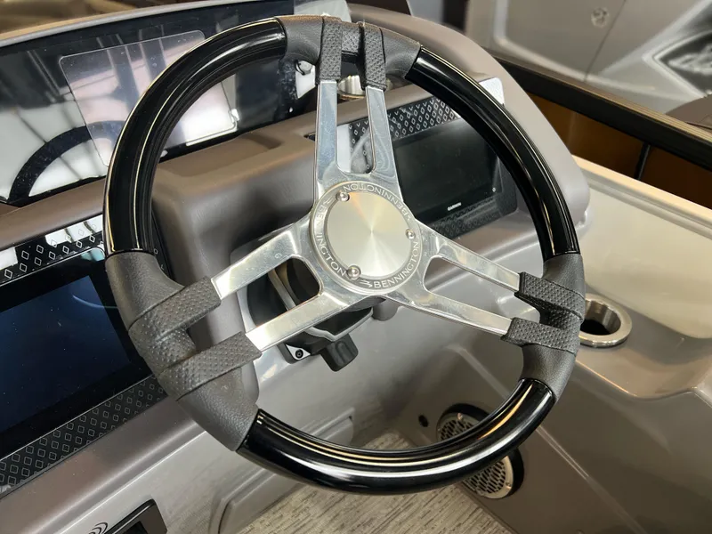 Slide: The Image of Steering wheel of 2025 Bennington R 24 RTFBA boat, featuring sleek design and modern controls. - 10