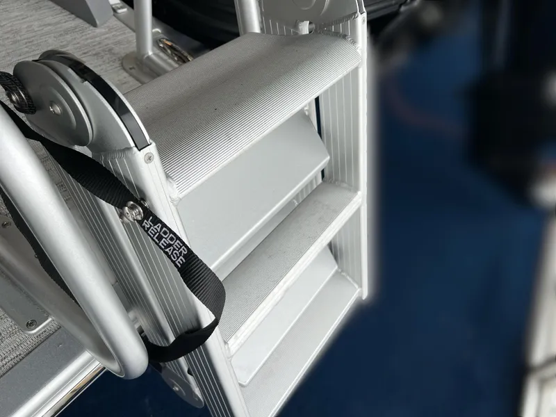 Slide: The Image of Aluminum boat ladder on 2025 Bennington R 24 RTFBA, featuring a secure release strap. - 4