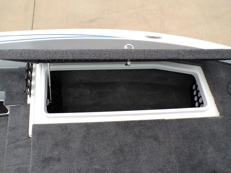 Slide: The Image of Open storage compartment in 2025 Phoenix 818 Pro boat, featuring carpeted interior. - 15