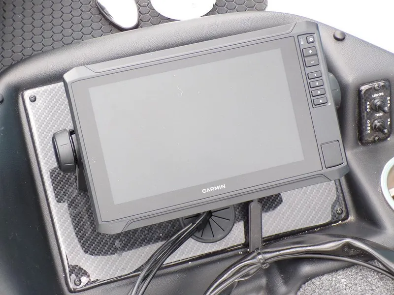 Slide: The Image of Garmin display on 2025 Phoenix 818 Pro boat dashboard, featuring carbon fiber panel. - 16