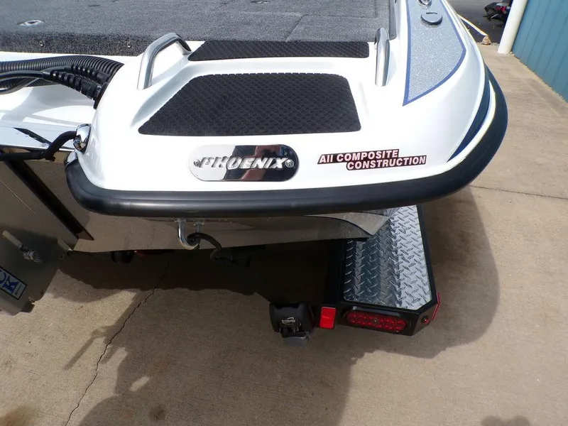 Slide: The Image of 2025 Phoenix 818 Pro boat with AI composite construction, rear view on trailer. - 25