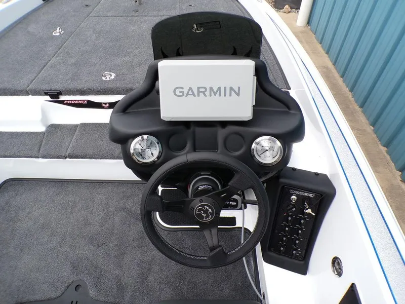 Slide: The Image of 2025 Phoenix 818 Pro boat dashboard with Garmin navigation system and steering wheel. - 8