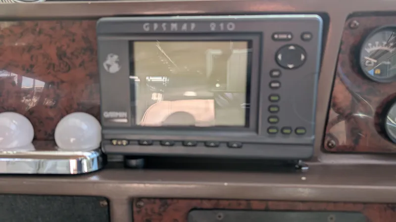 Slide: The Image of 1987 Sea Ray 390 Express Cruiser dashboard with GPSMAP 210 navigation system. - 26