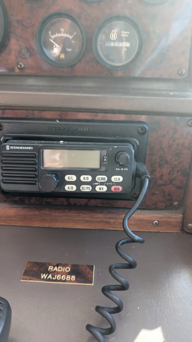 Slide: The Image of 1987 Sea Ray 390 Express Cruiser dashboard with radio and gauges. - 27