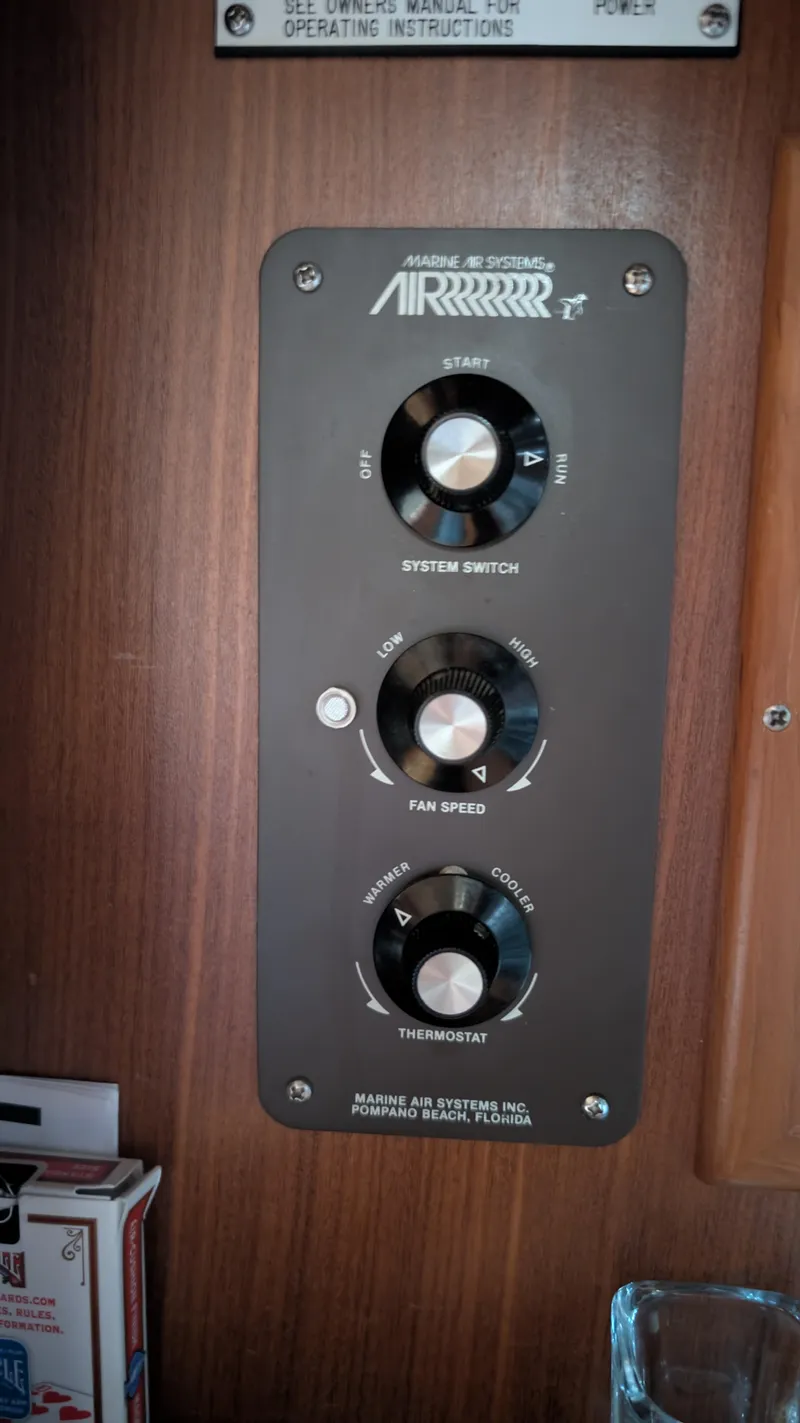Slide: The Image of Control panel of a 1987 Sea Ray 390 Express Cruiser with system switch and fan speed knobs. - 29
