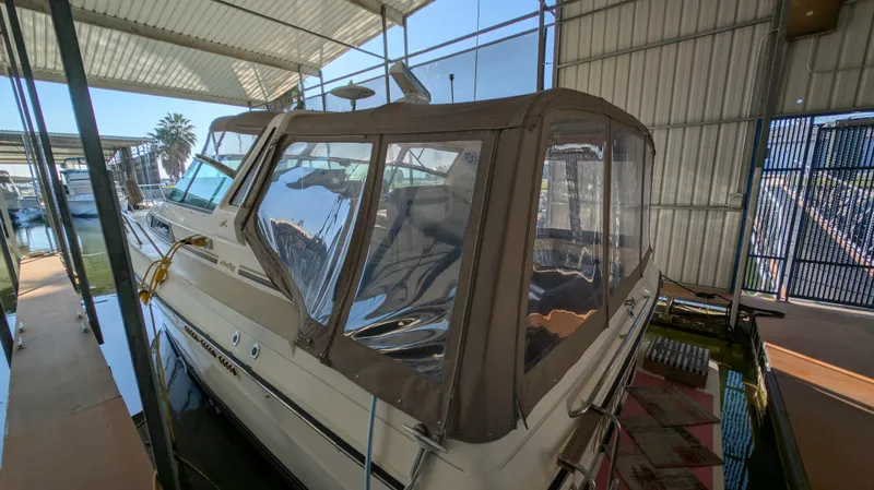 Slide: The Image of 1987 Sea Ray 390 Express Cruiser docked in covered marina. - 3