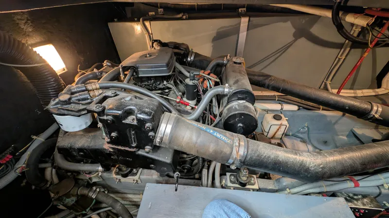 Slide: The Image of Engine compartment of a 1987 Sea Ray 390 Express Cruiser with visible components and hoses. - 33