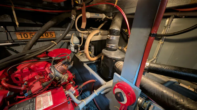 Slide: The Image of Engine room of a 1987 Sea Ray 390 Express Cruiser with visible components and wiring. - 37