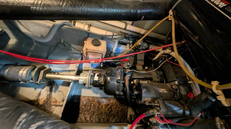 Slide: The Image of Engine compartment of a 1987 Sea Ray 390 Express Cruiser with visible components and wiring. - 39