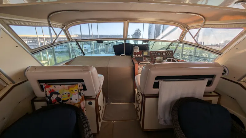 Slide: The Image of Interior of 1987 Sea Ray 390 Express Cruiser with helm and seating area. - 5