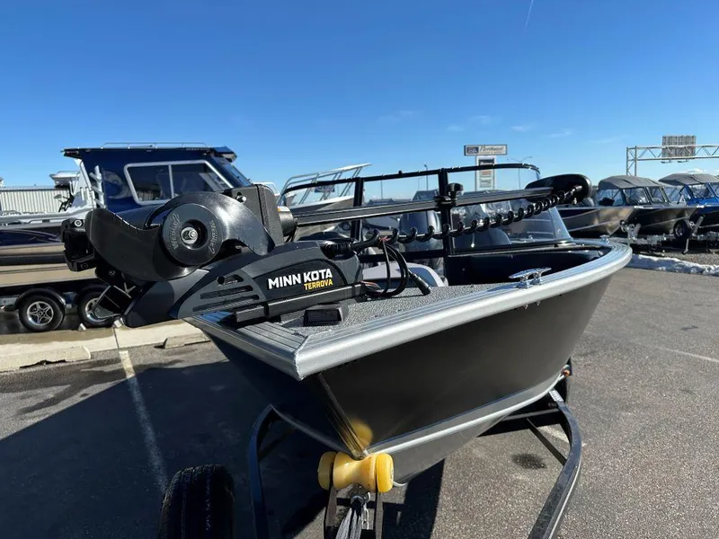 Slide: The Image of 2025 Starweld Fusion 18 DC boat with Minn Kota Terrova motor in a parking lot. - 3