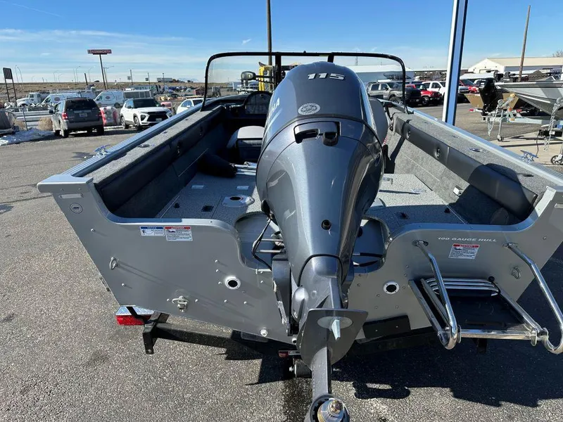 Slide: The Image of 2025 Starweld Fusion 18 DC boat with outboard motor, parked in a marina. - 4