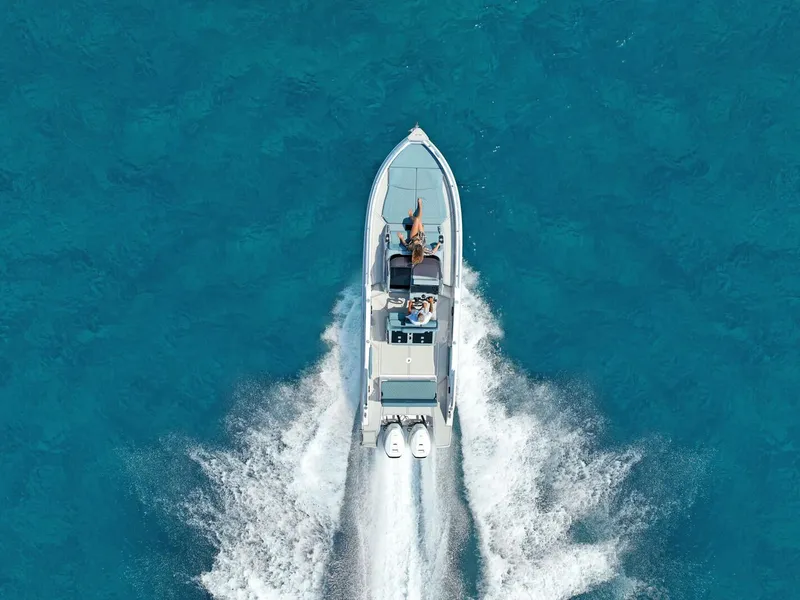 Slide: The Image of 2025 Ranieri NEXT 275 LX boat cruising on clear blue water, aerial view. - 10