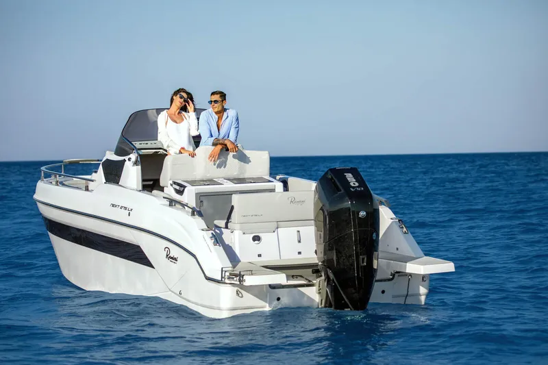 Slide: The Image of 2025 Ranieri NEXT 275 LX boat cruising on open sea with two passengers. - 12