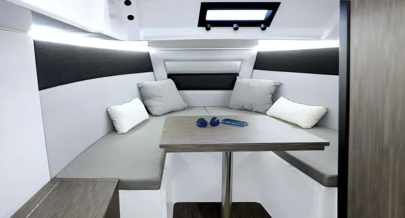 Slide: The Image of Interior of 2025 Ranieri NEXT 275 LX boat with modern seating and table. - 14