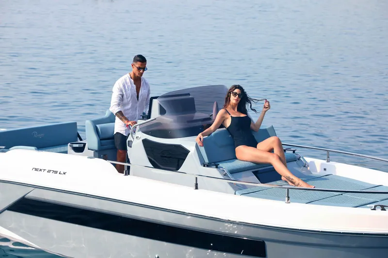 Slide: The Image of 2025 Ranieri NEXT 275 LX luxury boat with passengers enjoying a sunny day on the water. - 5