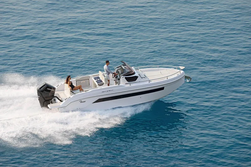 Slide: The Image of 2025 Ranieri NEXT 275 LX motorboat cruising on clear blue water. - 9