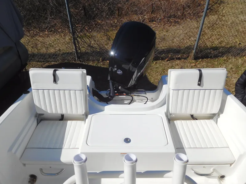 Slide: The Image of 2025 Bayliner Trophy T18Bay boat interior with seating and outboard motor. - 15
