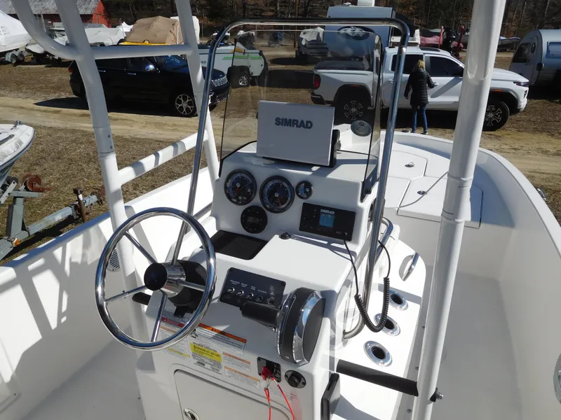 Slide: The Image of 2025 Bayliner Trophy T18Bay boat dashboard with steering wheel and navigation equipment. - 19