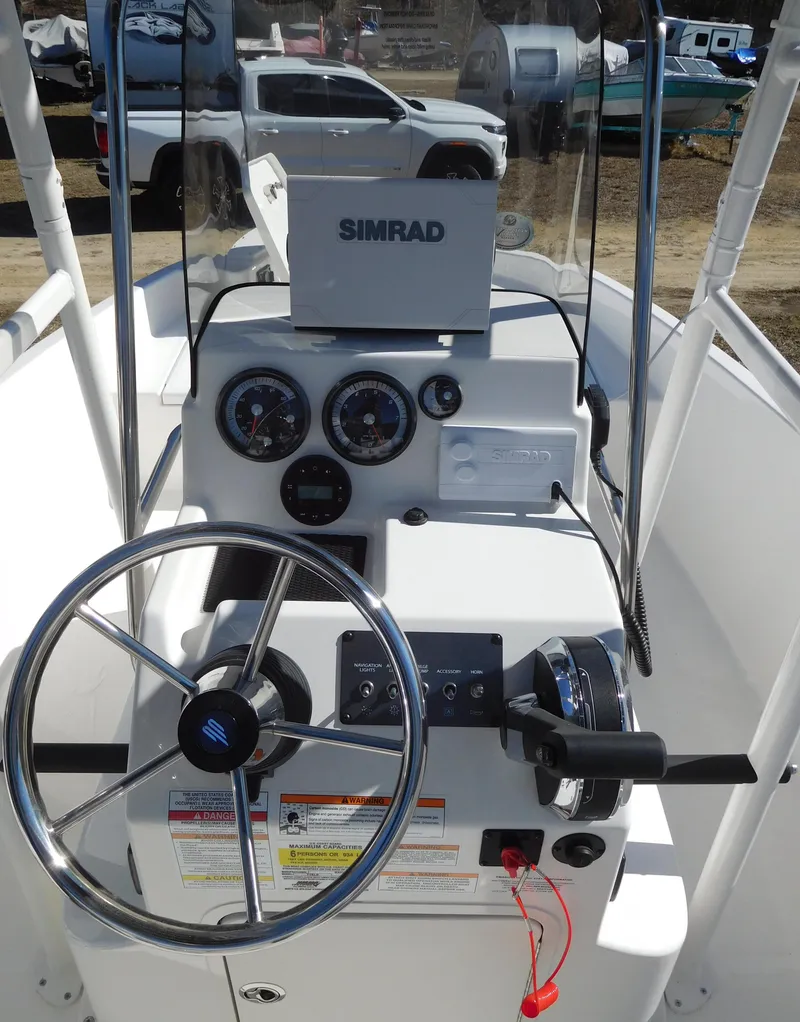 Slide: The Image of 2025 Bayliner Trophy T18Bay boat console with steering wheel and Simrad navigation system. - 20