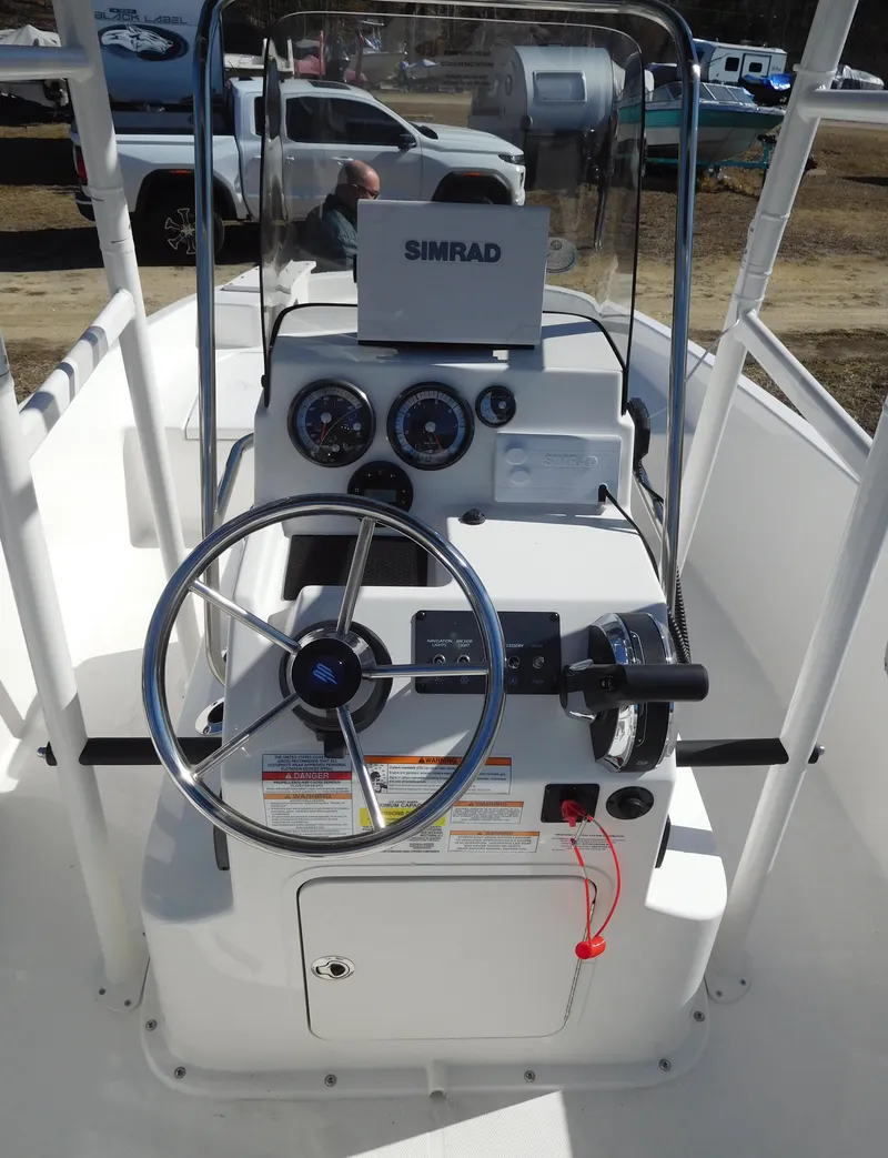 Slide: The Image of 2025 Bayliner Trophy T18Bay boat console with steering wheel and Simrad navigation system. - 21
