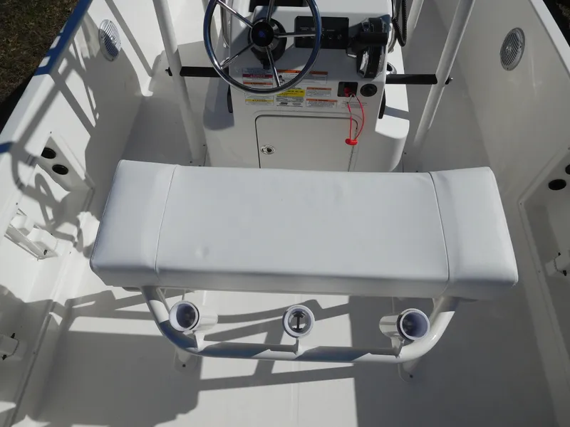 Slide: The Image of 2025 Bayliner Trophy T18Bay boat interior with steering console and cushioned seating. - 25