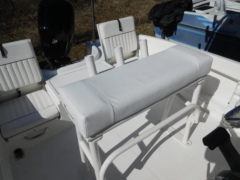 Slide: The Image of 2025 Bayliner Trophy T18Bay boat interior with white seating and rod holders. - 26