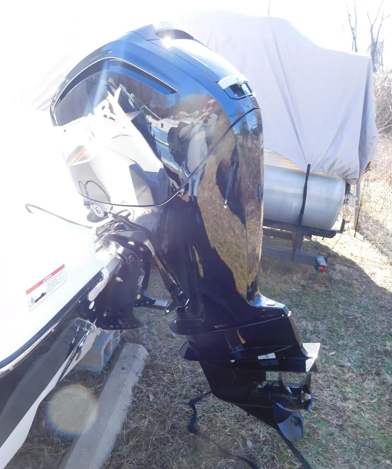 Slide: The Image of 2025 Bayliner Trophy T18Bay outboard motor, shiny black finish, parked on grass. - 31