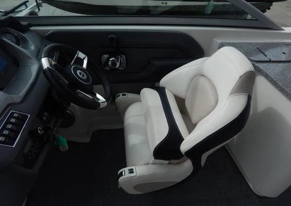 Slide: The Image of 2015 Chaparral 284 Sunesta boat cockpit with steering wheel and comfortable seating. - 19