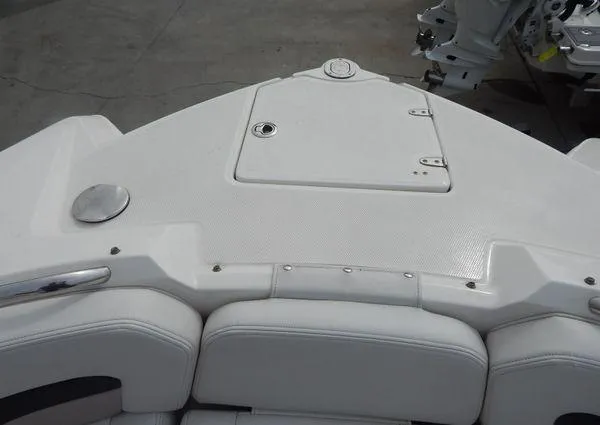 Slide: The Image of 2015 Chaparral 284 Sunesta boat deck with white seating and storage compartment. - 23