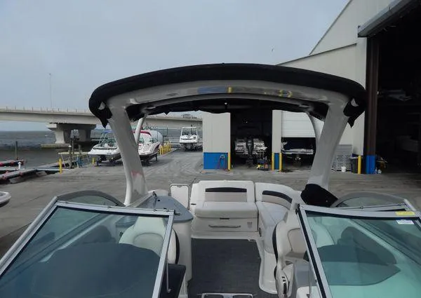Slide: The Image of 2015 Chaparral 284 Sunesta boat interior at a marina with storage facilities. - 26