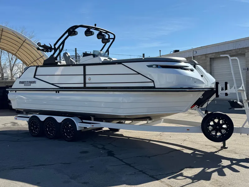 Slide: The Image of 2025 Montara 25' SURF BOSS 2.0 CWDH boat on trailer, parked outdoors. - 10