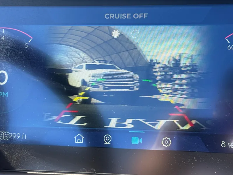 Slide: The Image of Dashboard display showing rearview camera with a white truck, Montara 25' SURF BOSS 2.0 CWDH, 2025. - 25