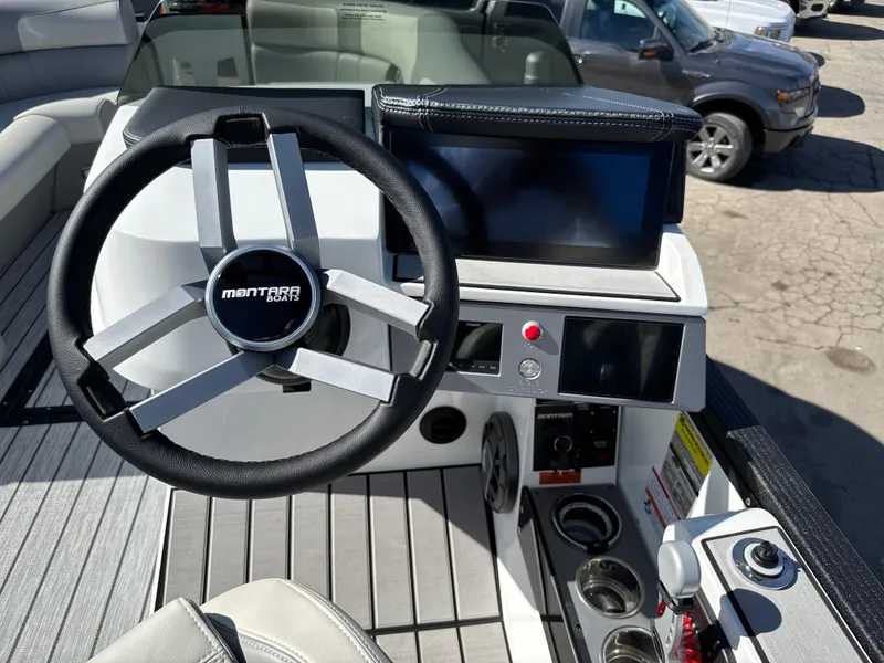 Slide: The Image of Steering console of 2025 Montara 25' SURF BOSS 2.0 CWDH boat with modern controls. - 26