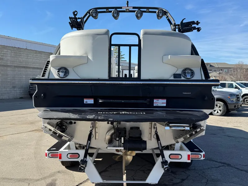 Slide: The Image of 2025 Montara 25' SURF BOSS 2.0 CWDH boat, rear view, parked outdoors. - 4