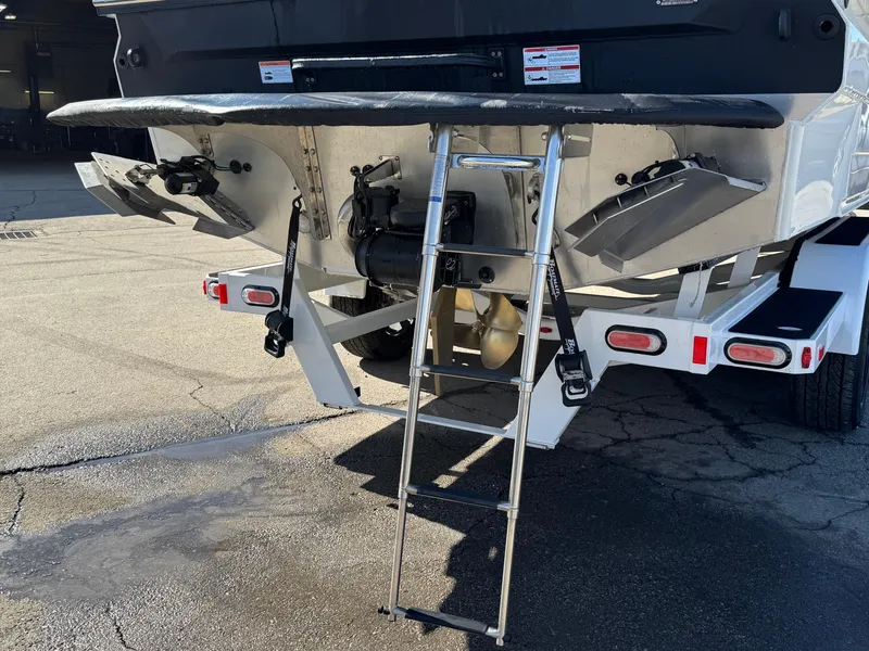 Slide: The Image of 2025 Montara 25' SURF BOSS 2.0 CWDH boat rear view with ladder and propeller. - 5