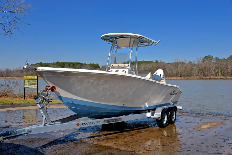 Slide: The Image of 2022 Sea Chaser 22 HFC boat on trailer by a lake under clear blue sky. - 10