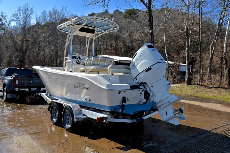Slide: The Image of 2022 Sea Chaser 22 HFC boat on trailer, parked near wooded area. - 12