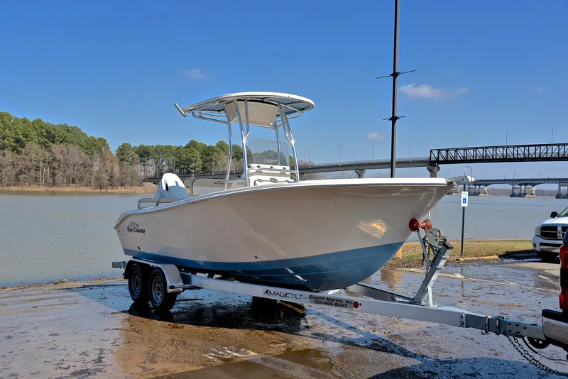 Slide: The Image of 2022 Sea Chaser 22 HFC boat on trailer by a lake with a bridge in the background. - 16