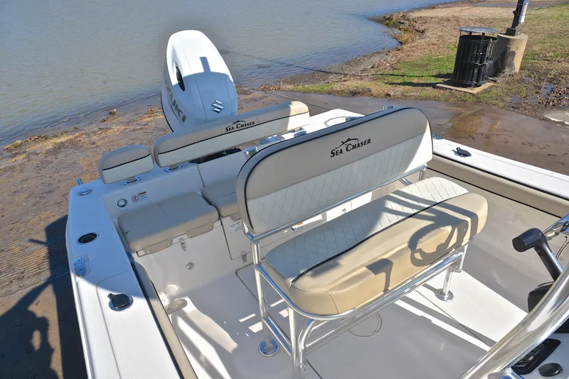 Slide: The Image of 2022 Sea Chaser 22 HFC boat with seating and outboard motor by the water. - 19