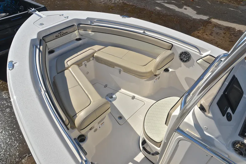 Slide: The Image of 2022 Sea Chaser 22 HFC boat interior with beige seating and modern console. - 22