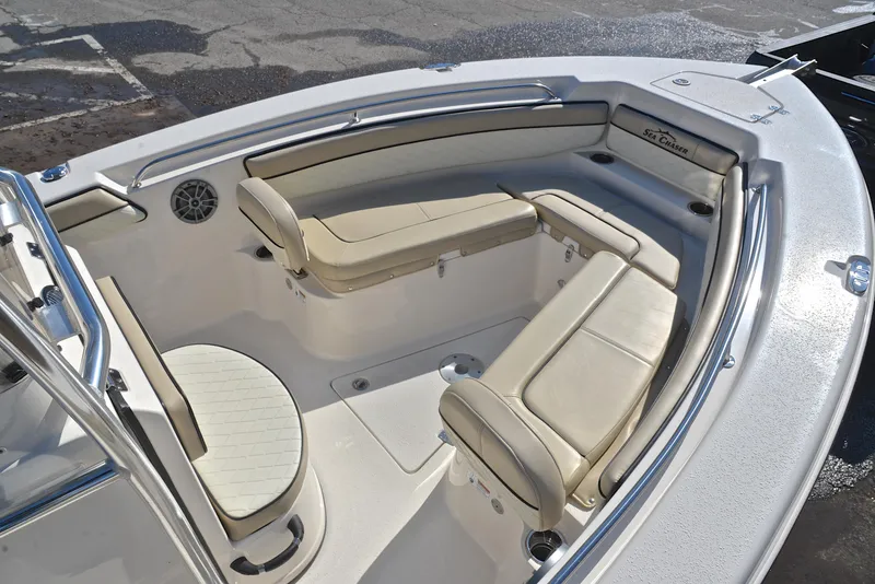 Slide: The Image of 2022 Sea Chaser 22 HFC boat interior with beige seating and sleek design. - 23