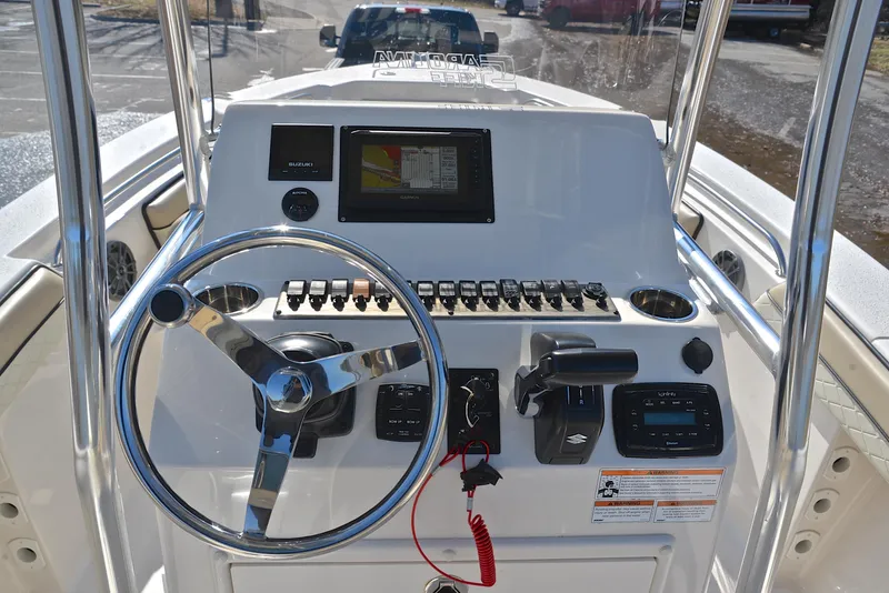 Slide: The Image of 2022 Sea Chaser 22 HFC boat dashboard with steering wheel and navigation controls. - 25