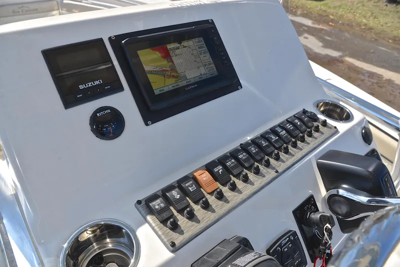 Slide: The Image of Control panel of 2022 Sea Chaser 22 HFC boat with navigation display and switches. - 26