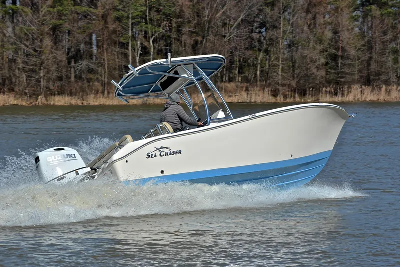 Slide: The Image of 2022 Sea Chaser 22 HFC boat cruising on a lake with trees in the background. - 28